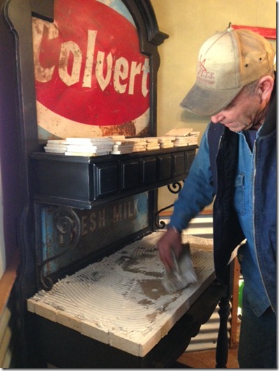 Steve applying adhesive glue to Coffee Station