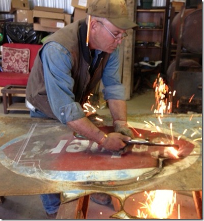 cutting torch being use to modify an old sign