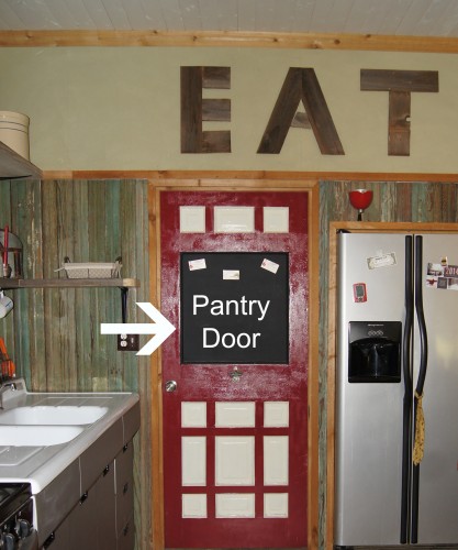 The lack of conventional cabinets is possible because of what is behind this door! A pantry:)